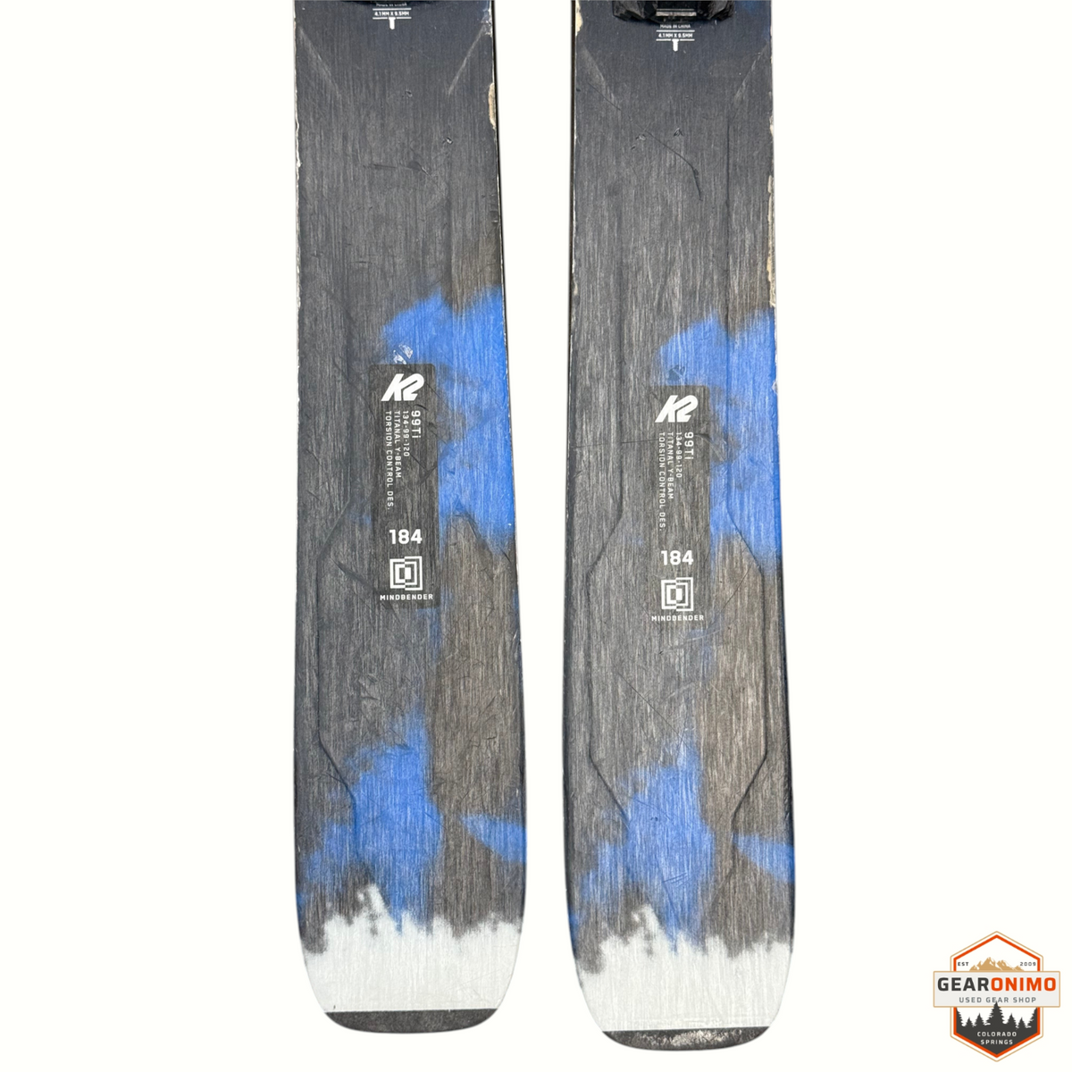 Gearonimo Sports K2 Mindbender 99ti skis in 184cm length with blue and grey graphic design and Salomon M11 bindings