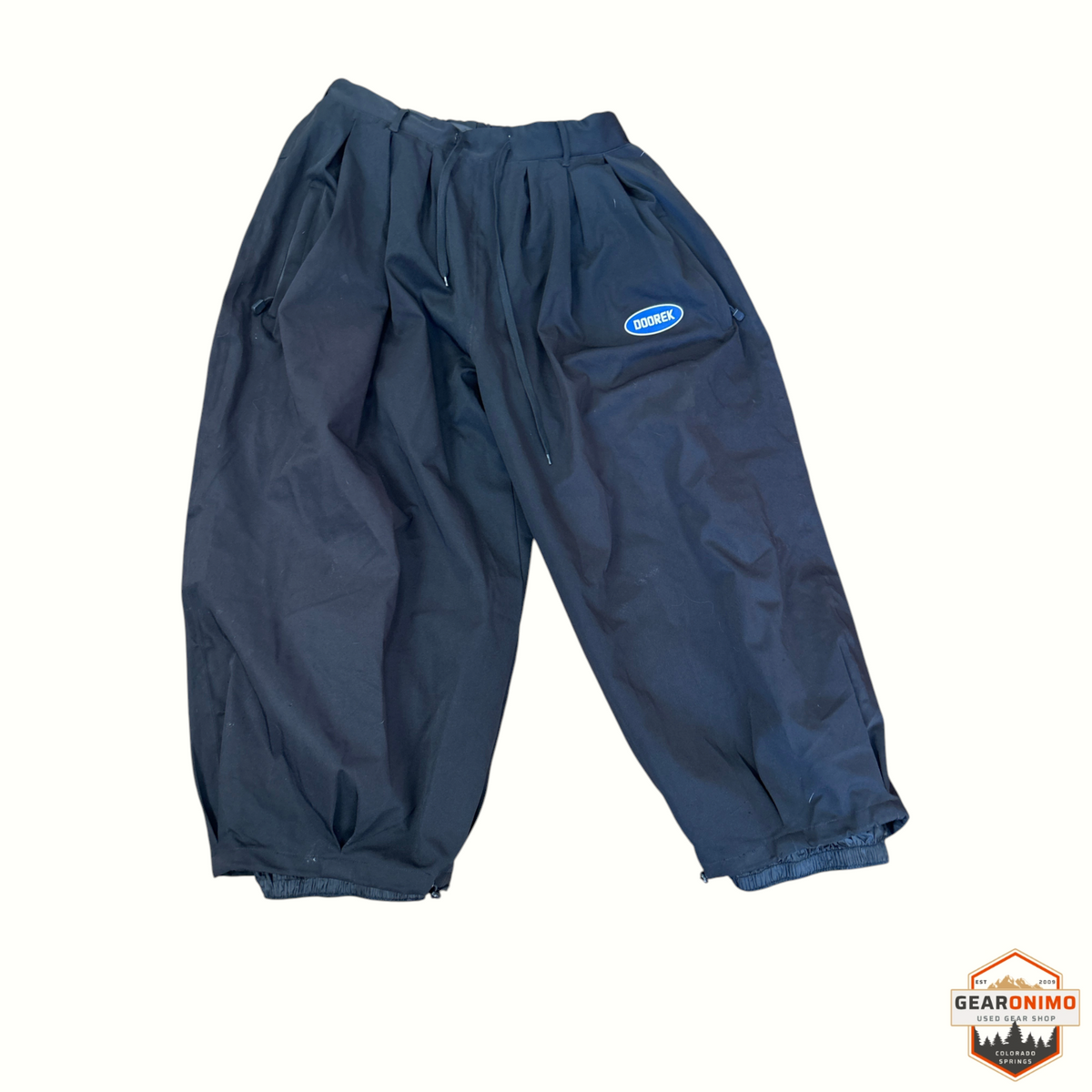 Gearonimo Sports Doorek unisex black super baggy snow pants with a blue logo patch and elasticated cuffs.