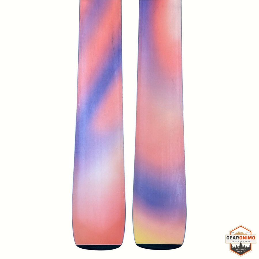 Gearonimo Sports Salomon Qst 94 skis with a vibrant orange, purple, and yellow gradient base design