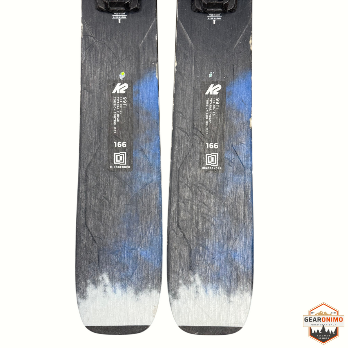 Gearonimo Sports K2 Mindbender 99ti 166cm skis with blue and black graphic design and Titanal beam construction