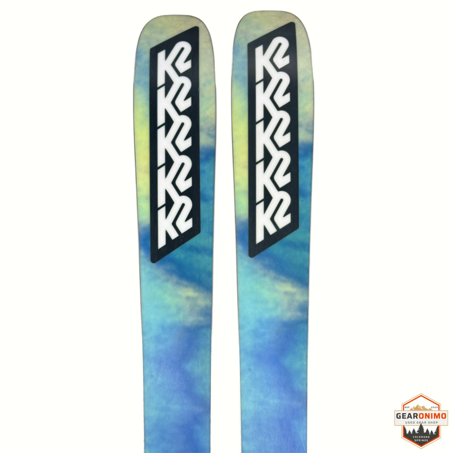 Gearonimo Sports K2 Mindbender 99ti skis with blue and yellow tie-dye pattern and black K2 logo branding