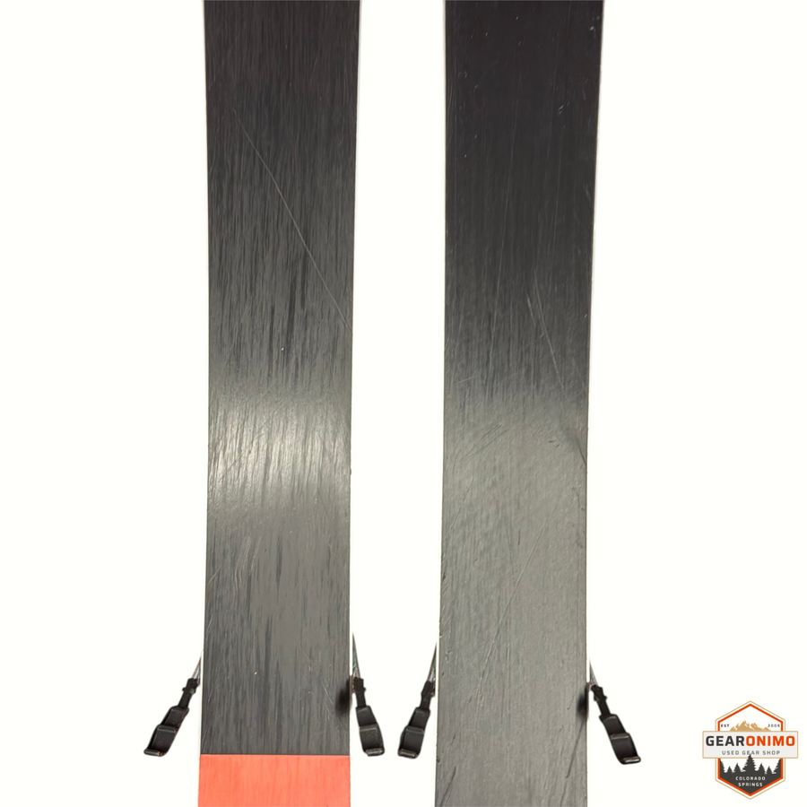 Gearonimo Sports Blizzard Sheeva 9 skis with Marker Squire 11 bindings, showing black bases with orange tail detail.