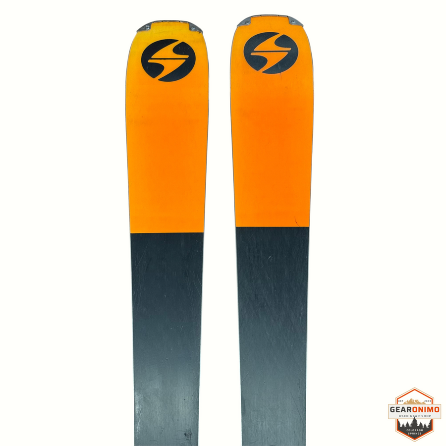 Gearonimo Sports Blizzard Anomaly 94 skis featuring a vibrant orange and black design with the Blizzard logo.