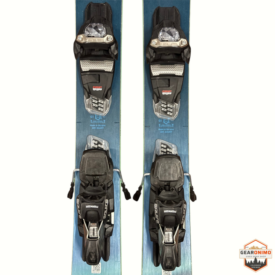 Gearonimo Sports Blizzard Sheeva 9 skis in blue with mounted black Marker Squire 11 bindings, top-down view.