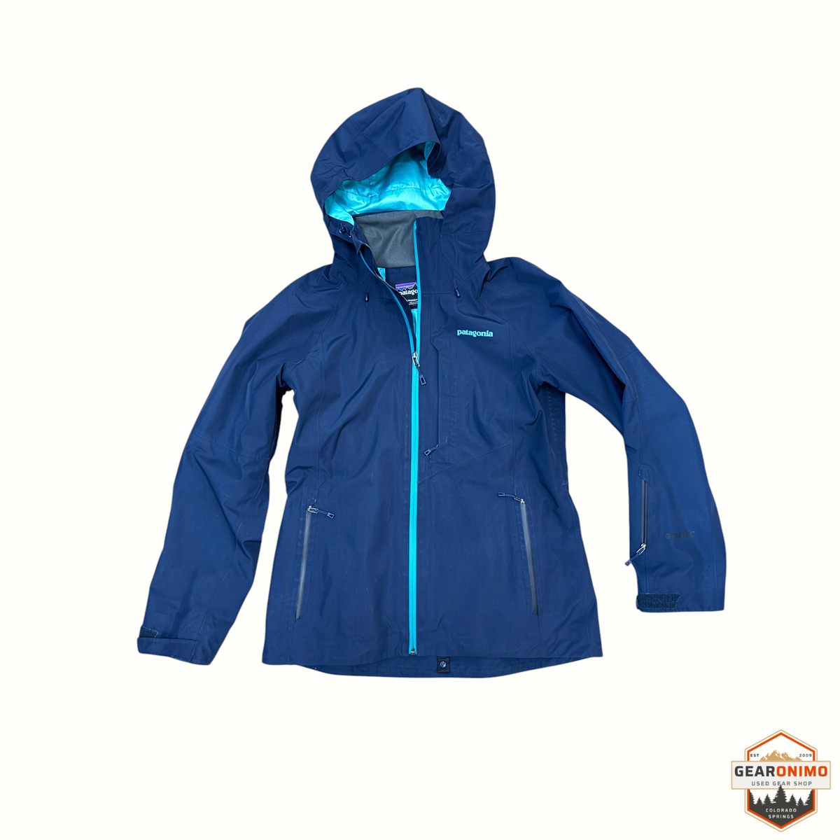 Gearonimo Sports women's Patagonia Powder Bowl ski jacket in navy blue with a bright teal zipper and hood lining.