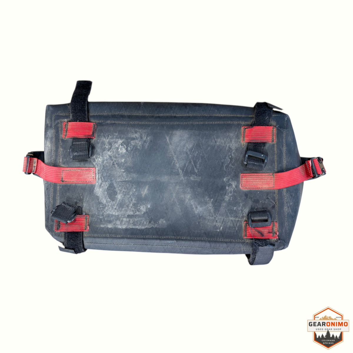 Gearonimo Sports Revelate Designs black bike bag with red nylon straps and velcro attachments