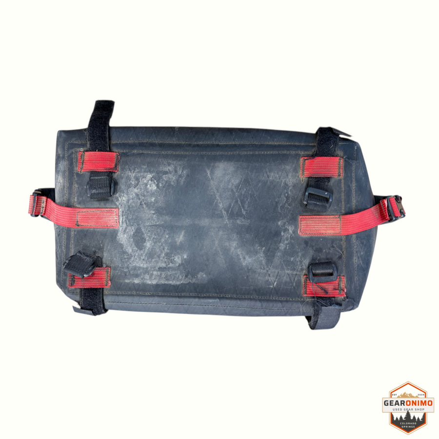 Gearonimo Sports Revelate Designs black bike bag with red nylon straps and velcro attachments
