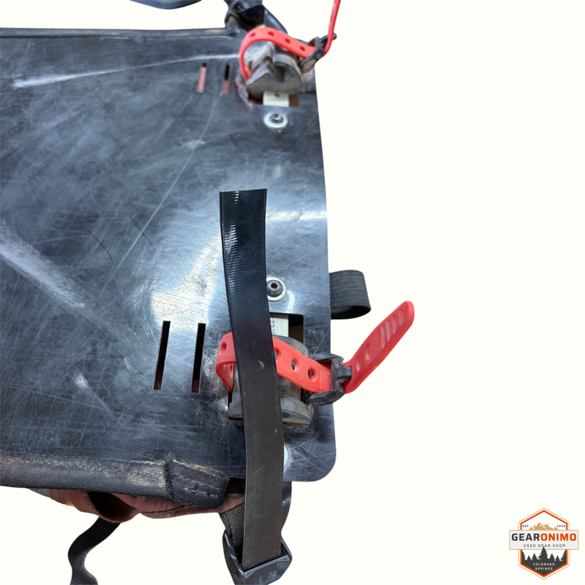 Gearonimo Sports Revelate Designs pannier mounting plate with black plastic backing and red rubber straps