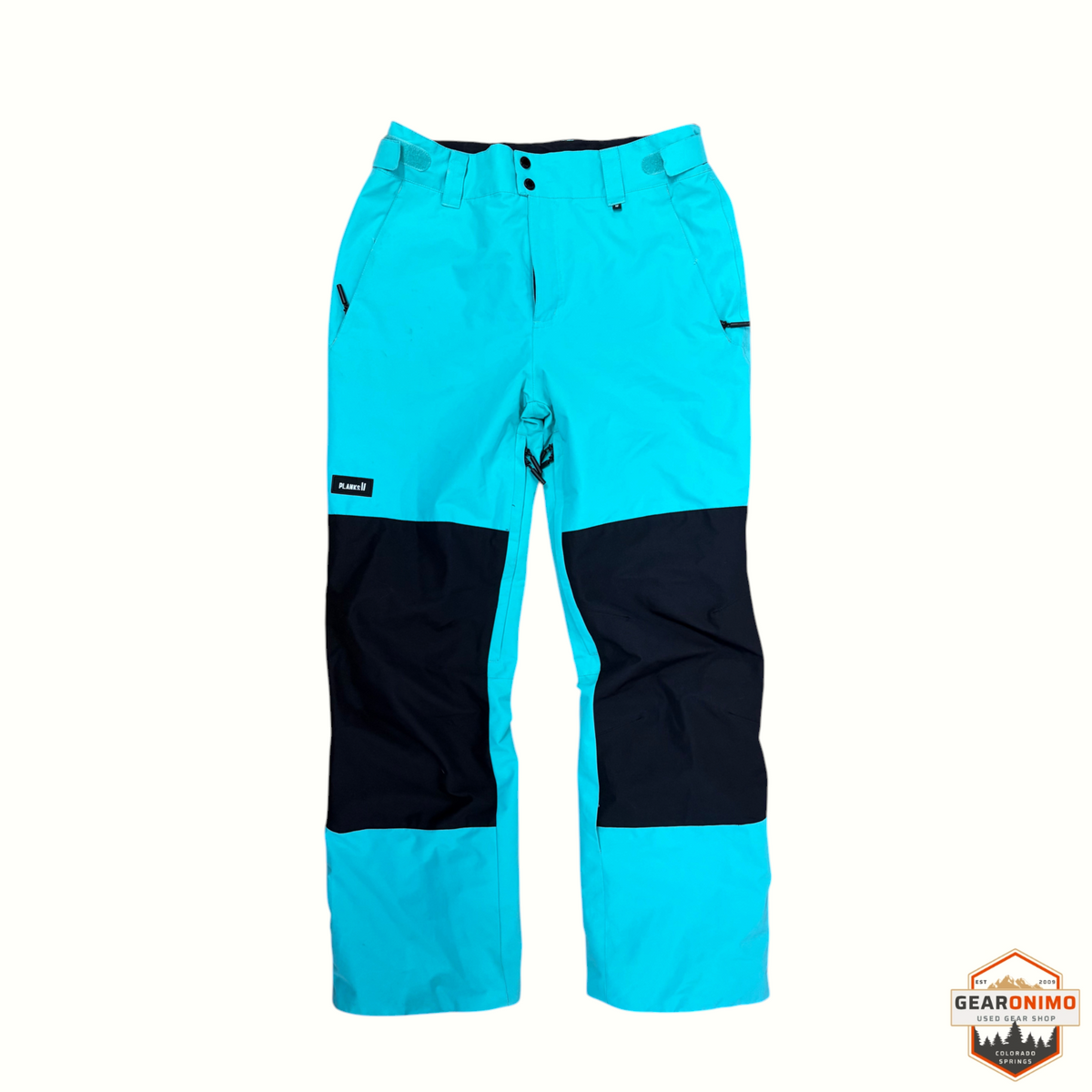 Gearonimo Sports Planks Good Times ski pants in bright turquoise with black knee panels and adjustable waist tabs.
