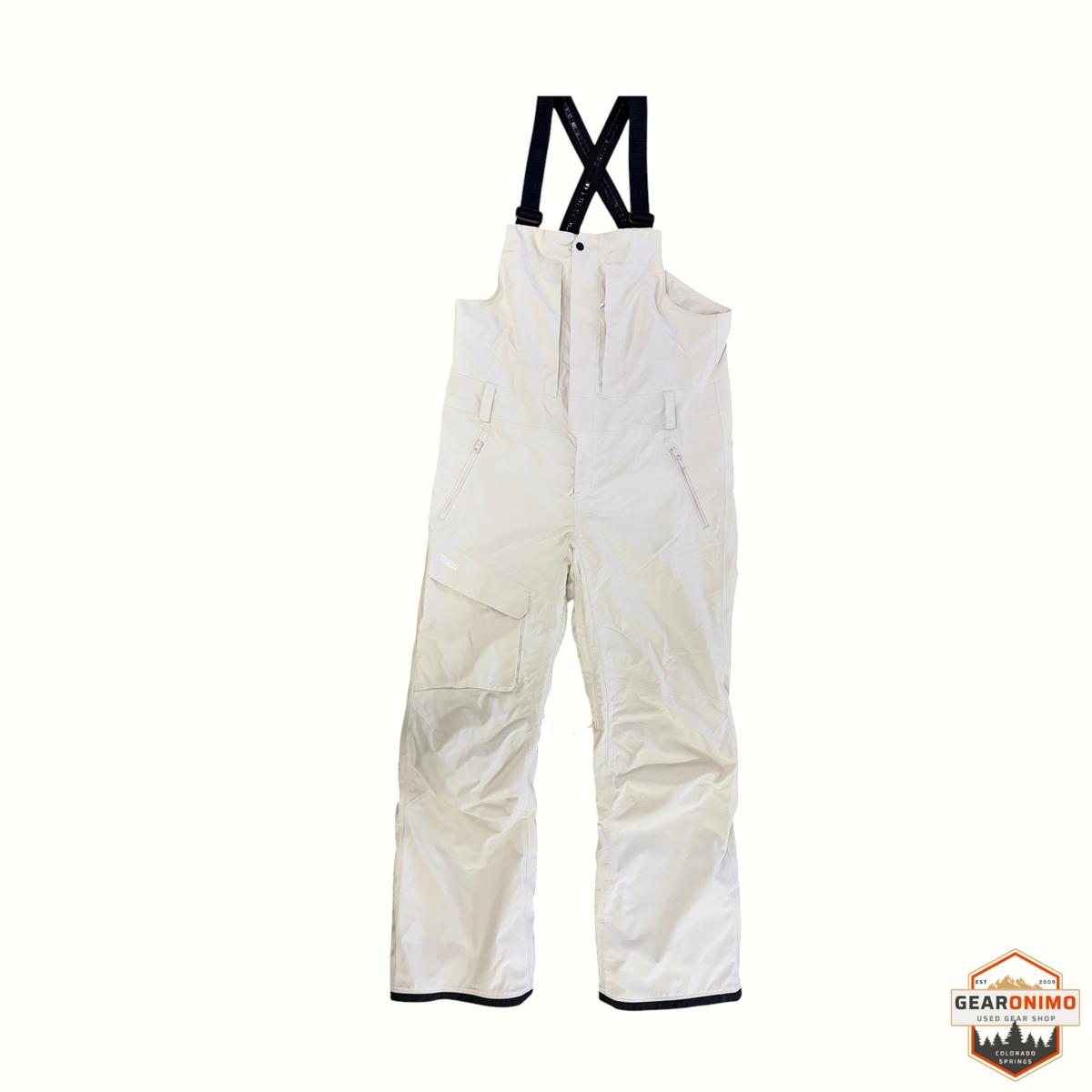 Gearonimo Sports Trew Gear Jefferson snow bibs in off-white with black adjustable suspenders and front zip pockets.