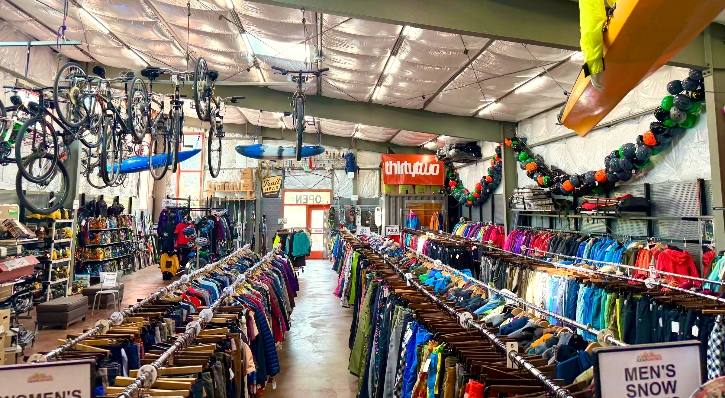 Clothing racks, bicycles, and outdoor gear inside Gearonimo Sports in Colorado Springs