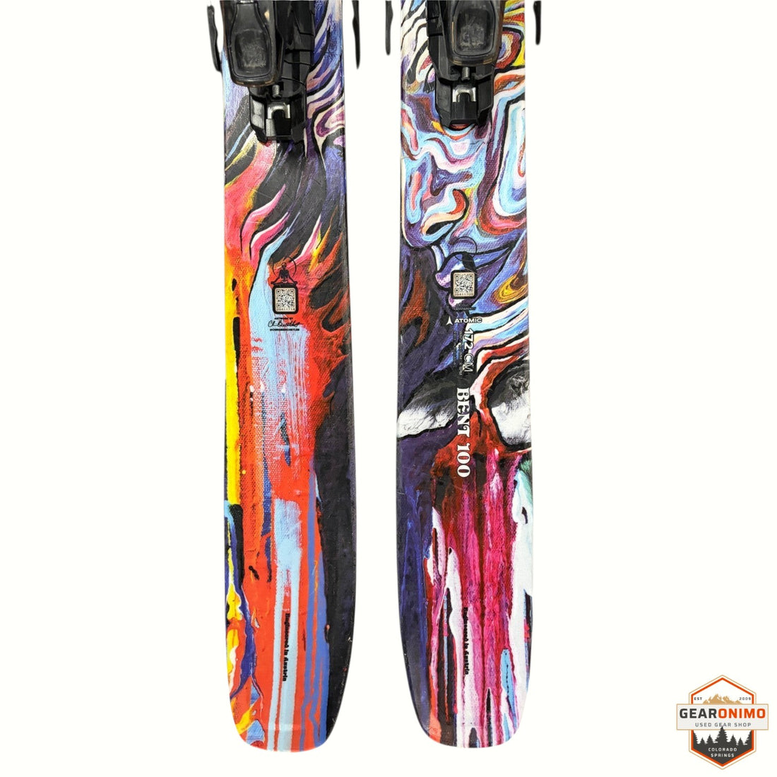 Gearonimo Sports Atomic Bent 100 skis with Strive 11 bindings, featuring vibrant abstract multi-color graphic design.