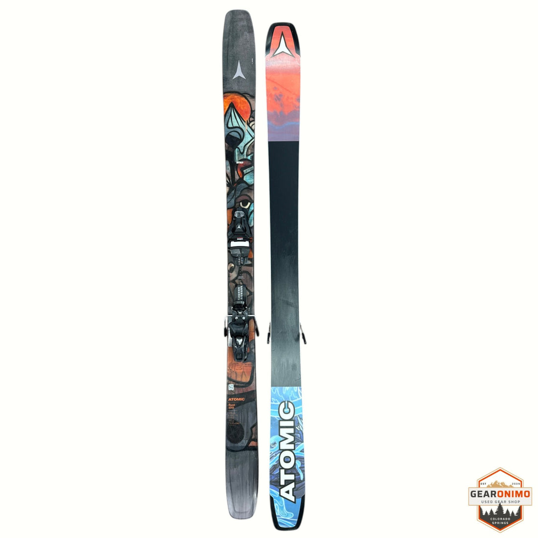 Gearonimo Sports Atomic Bent 100 skis featuring colorful graphic topsheets and black bases on a textured floor