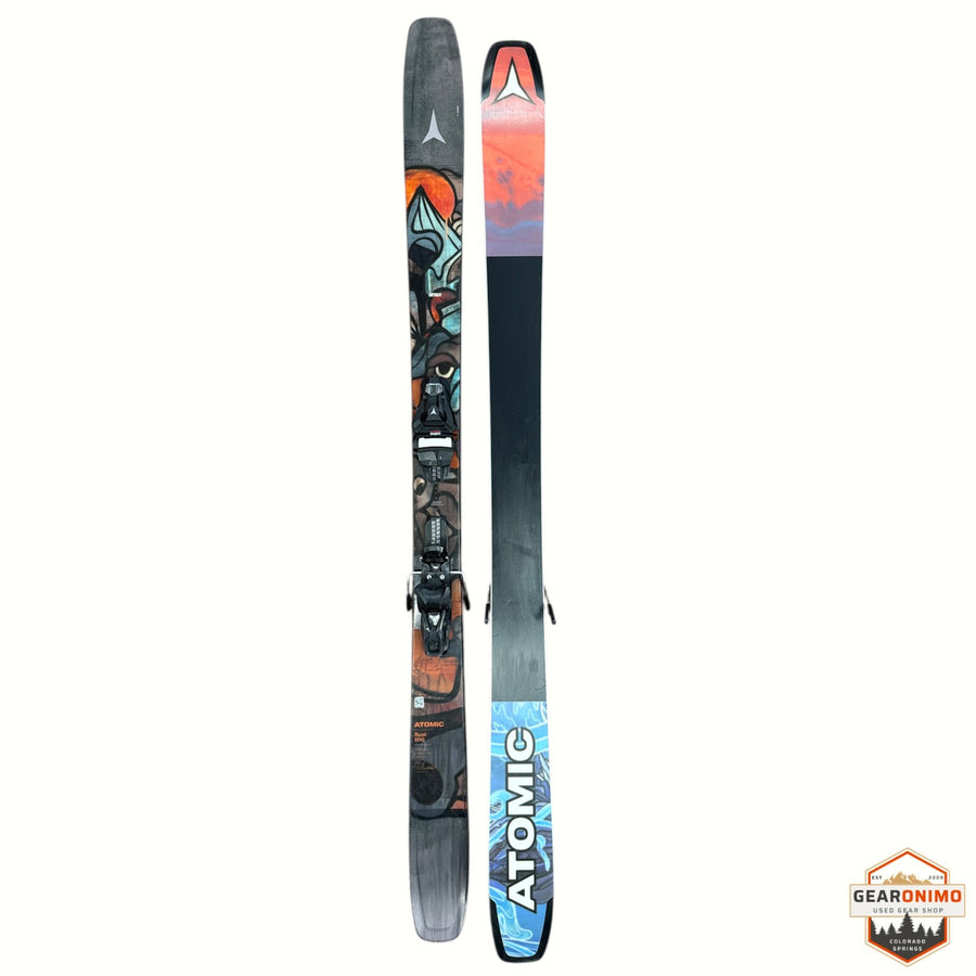 Gearonimo Sports Atomic Bent 100 skis featuring colorful graphic topsheets and black bases on a textured floor