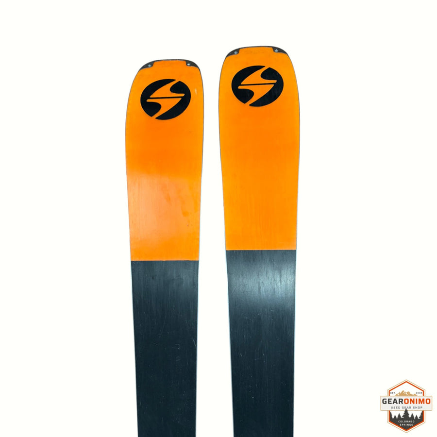 Gearonimo Sports Blizzard Anomaly 88 skis featuring bright orange tips with black logos and dark grey bases