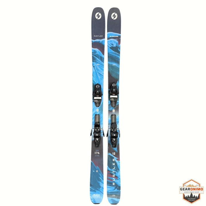 Gearonimo Sports Blizzard Rustler 10 skis in blue with black bindings, 174 cm length, on a brown floor with a dog.