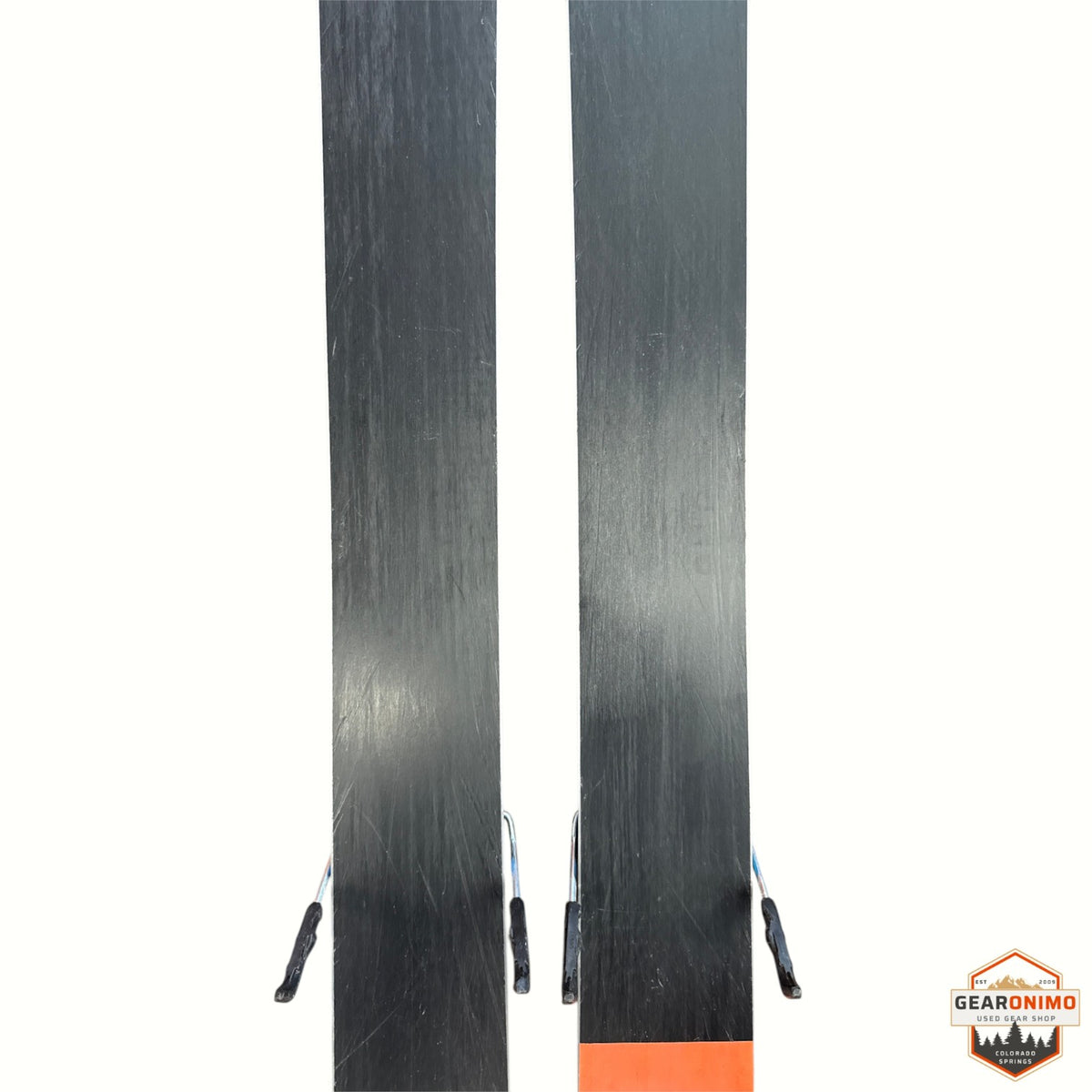 Gearonimo Sports Blizzard Rustler 10 skis, 174 cm length, showing black bases with minor surface wear on brown floor.