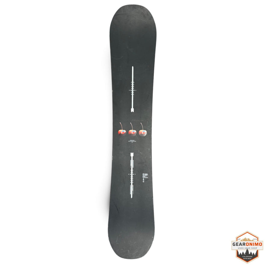 Gearonimo Sports Burton Cultivator snowboard in black with a three-cherry graphic design on a concrete floor