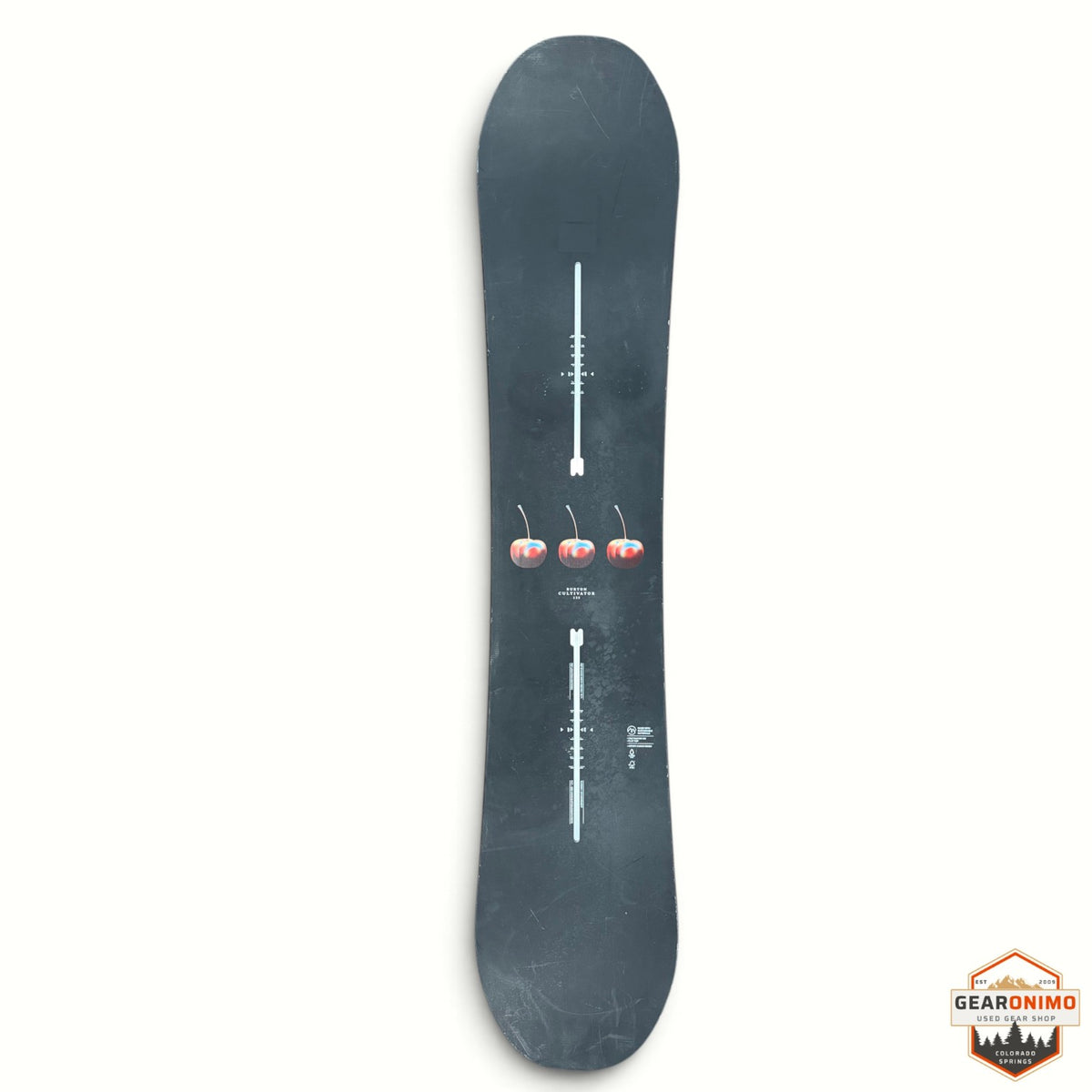 Gearonimo Sports Burton Cultivator snowboard in black with a three-cherry graphic on a red concrete floor.
