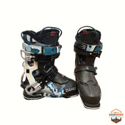 Gearonimo Sports Dahu Ecorce 01 ski boots featuring a black and blue camouflage pattern with adjustable buckles.