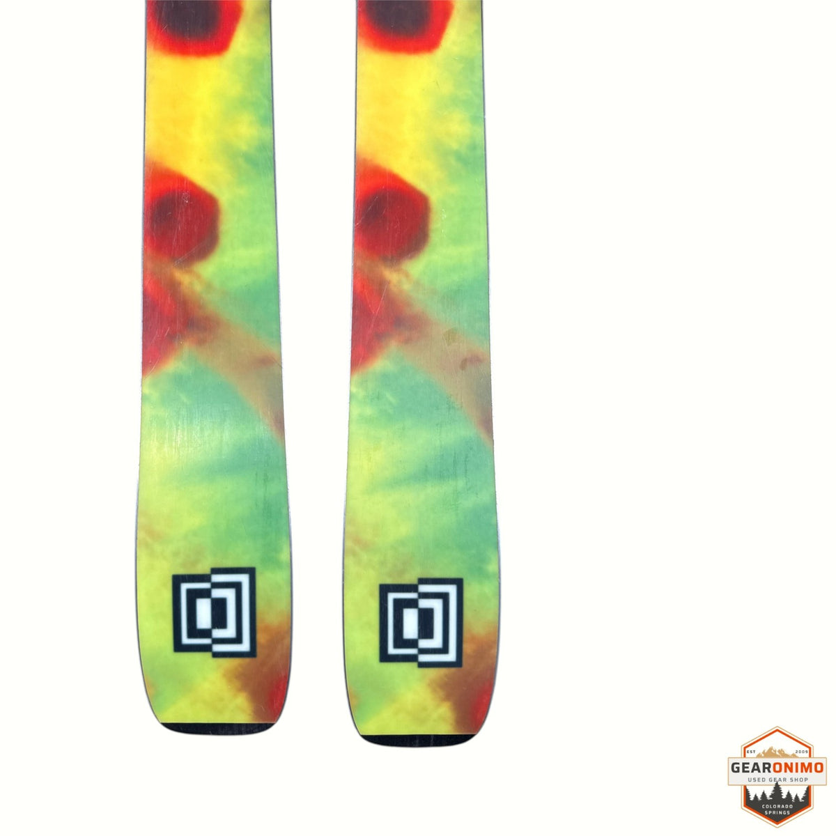 Gearonimo Sports K2 Mind Bender 89 Ti skis featuring a vibrant yellow, green, and red tie-dye graphic design