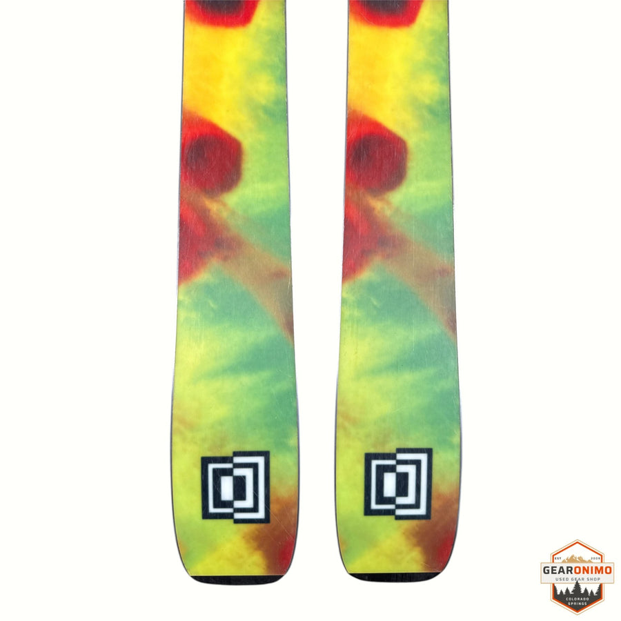 Gearonimo Sports K2 MindBender 89Ti skis with a vibrant yellow, green, and red tie-dye pattern on the tips