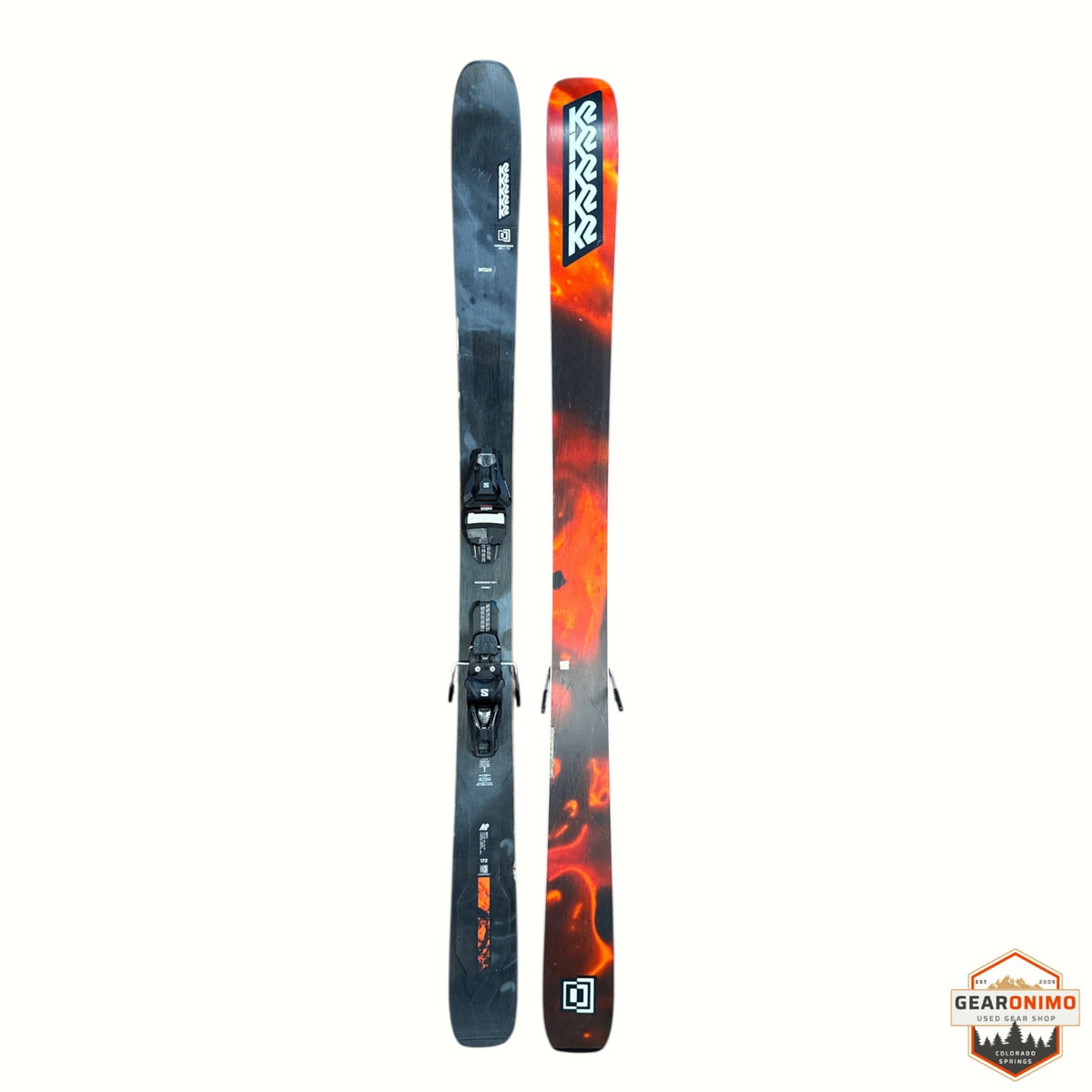 Gearonimo Sports K2 Mindbender 99TI skis featuring a black and orange flame graphic design with mounted bindings