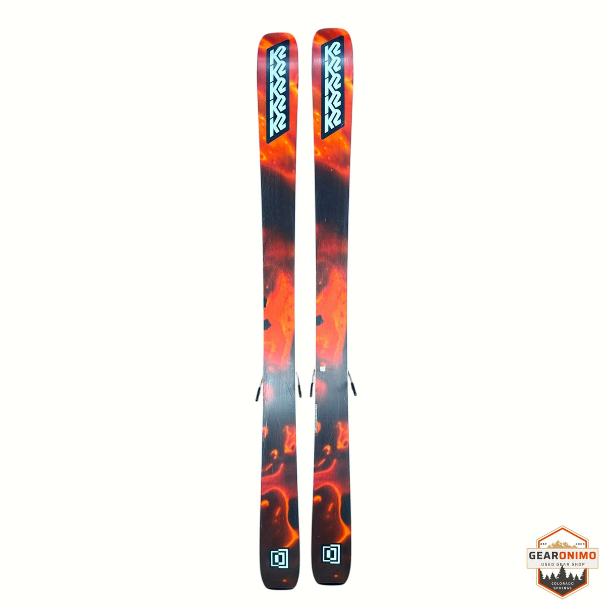 Gearonimo Sports K2 Mindbender 99TI skis featuring a vibrant orange and black flame-inspired graphic design