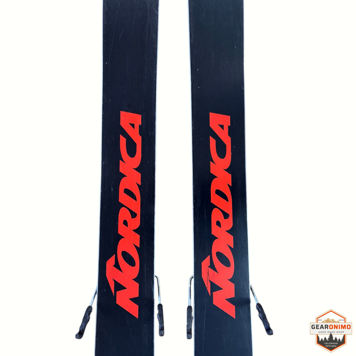 Gearonimo Sports Nordica Enforcer 99 skis in black with red branding, featuring Salomon Strive 11 bindings