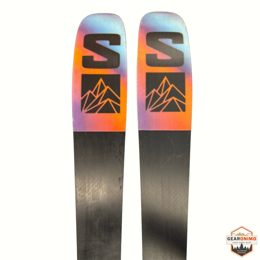 Gearonimo Sports Salomon QST 92 skis featuring a vibrant gradient tip and black base with mountain logo