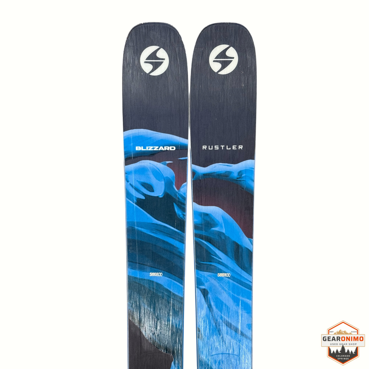 Gearonimo Sports Blizzard Rustler 10 skis in black and blue with abstract mountain graphic design