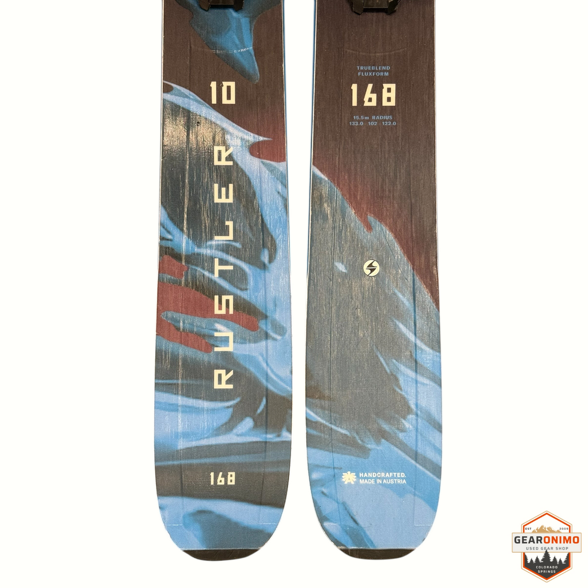 Gearonimo Sports Blizzard Rustler 10 skis with 168cm length, blue and wood grain graphic, and Salomon Strive bindings.