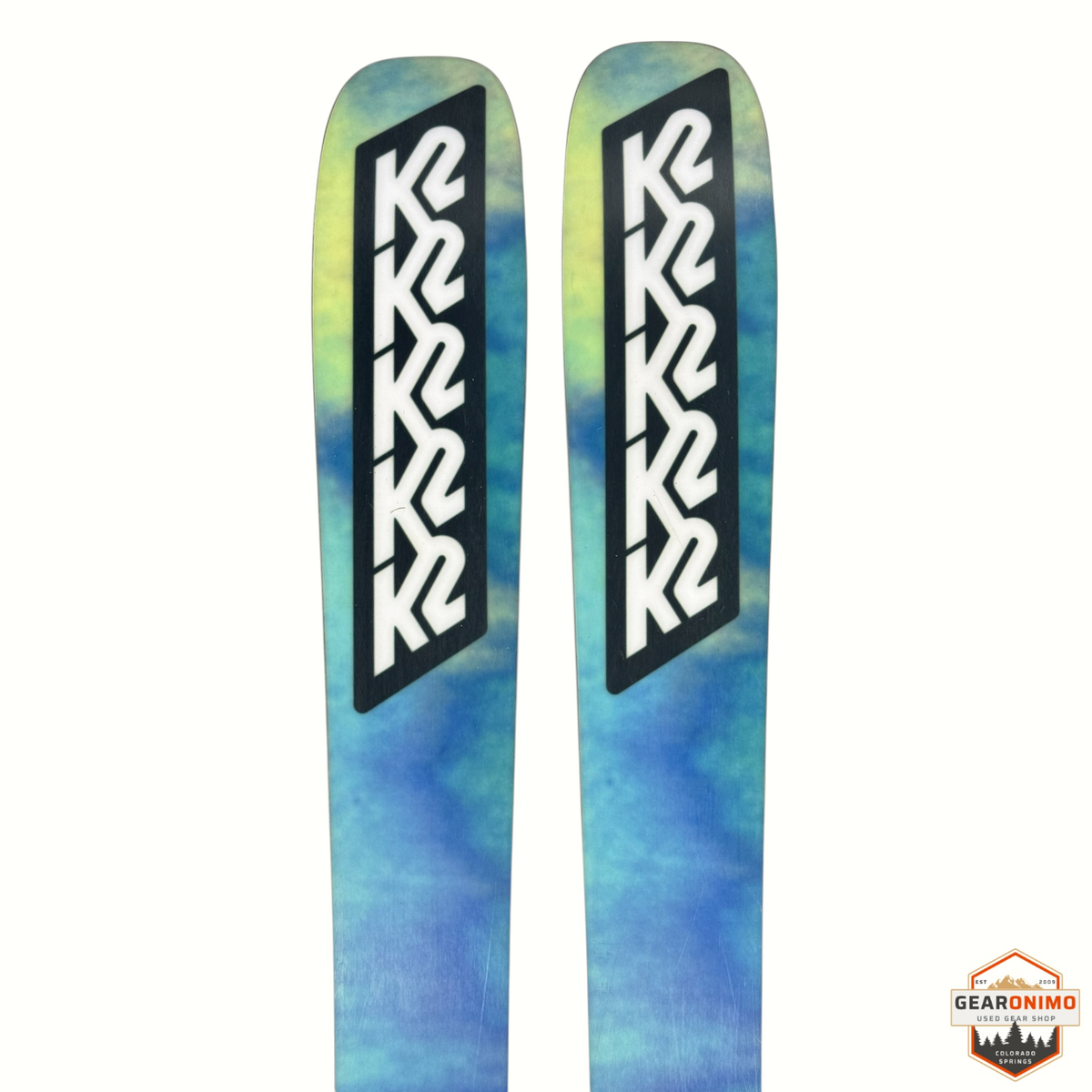 Gearonimo Sports K2 Mindbender 99ti skis featuring a blue and yellow tie-dye design with black K2 branding